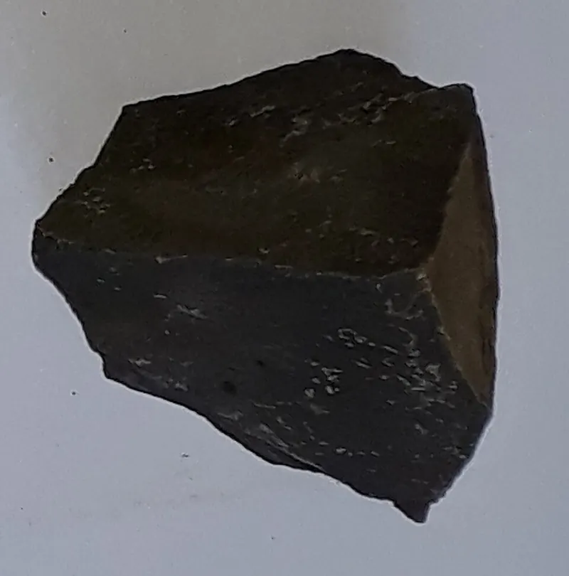A piece of dark, fine-grained basalt rock