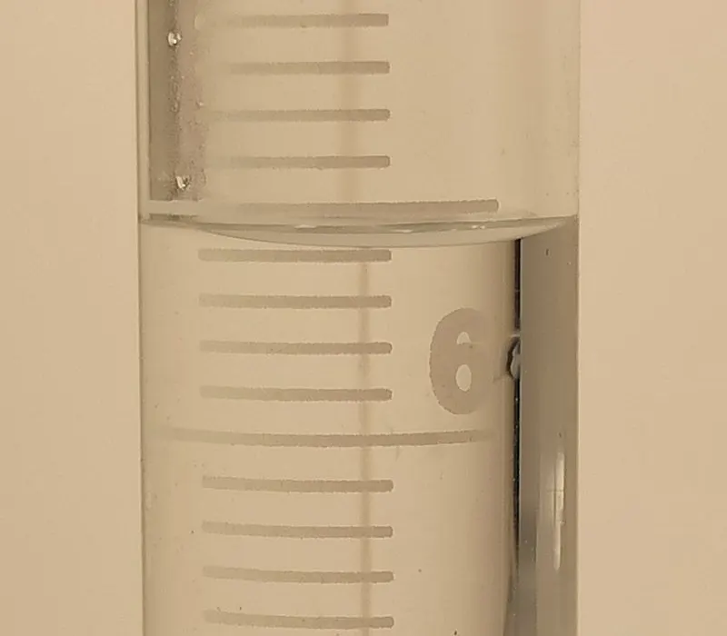 Water in a glass measuring cylinder, showing the curved surface
