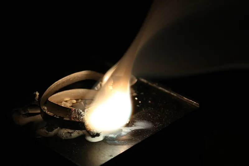 A strip of magnesium ribbon burning with a very bright white flame